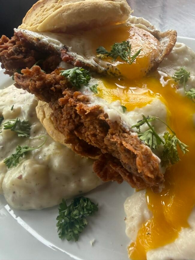 Lindberg's Tavern brunch on C-Street: a crispy fried cutlet, runny egg, and biscuits and gravy.