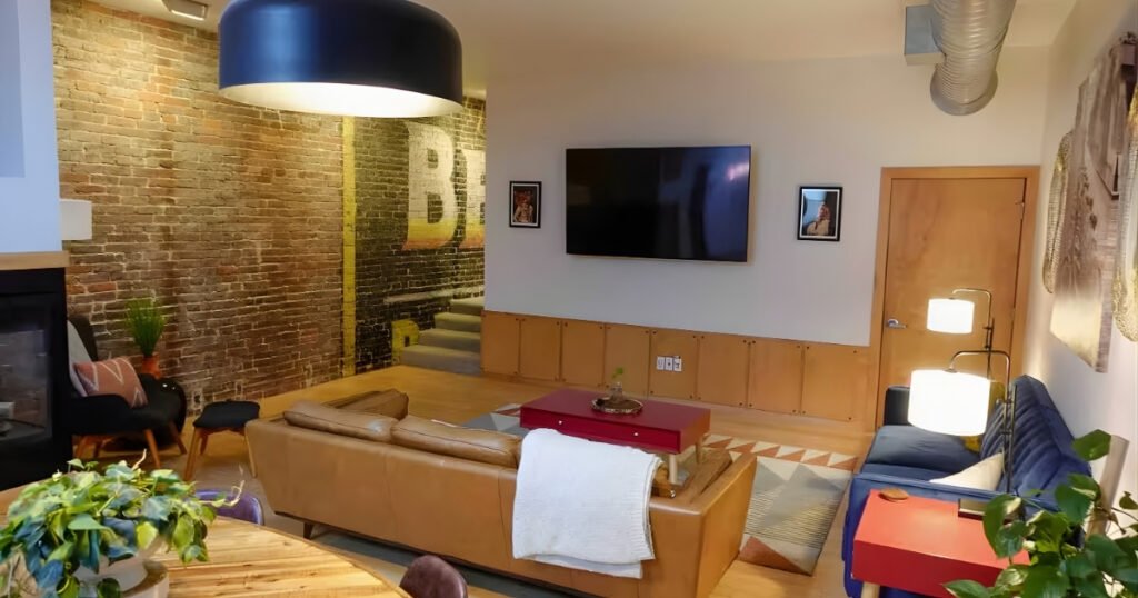 The Beemans Brick Loft living room with exposed brick and mid-century decor on Historic C-Street.