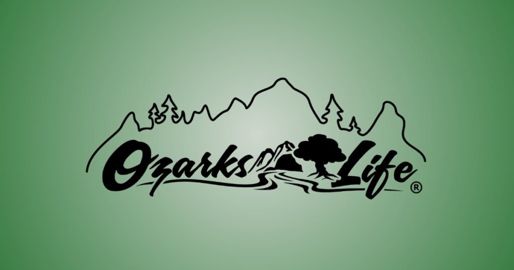 Ozarks Life logo with a mountain and tree emblem, an Ozarks lifestyle brand featured on Historic C-Street, MO.