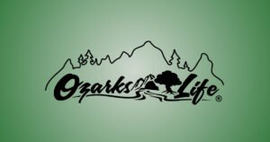 Ozarks Life logo with a mountain and tree emblem, an Ozarks lifestyle brand featured on Historic C-Street, MO.