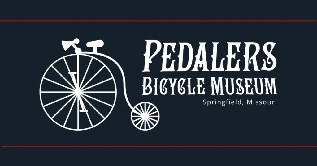 Pedalers Bicycle Museum logo with a penny-farthing, on Historic Commercial Street in Springfield, Missouri.