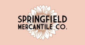 Springfield Mercantile Co. logo with a sunflower emblem, a mercantile shop on Historic C-Street, Springfield, MO.