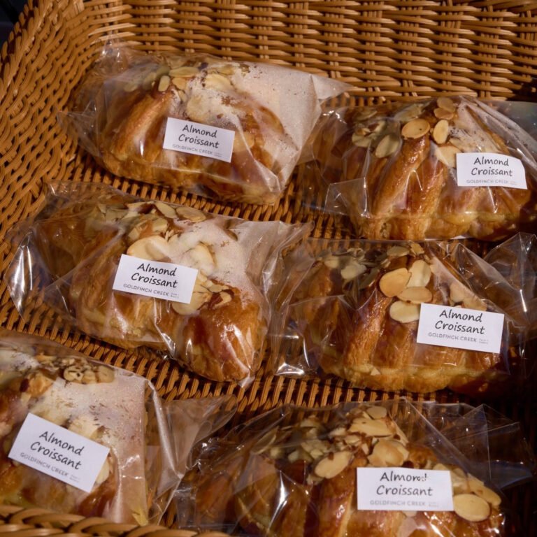 A basket of bagged almond croissants from Goldfinch Creek Farm & Bakery at the C-Street City Market.
