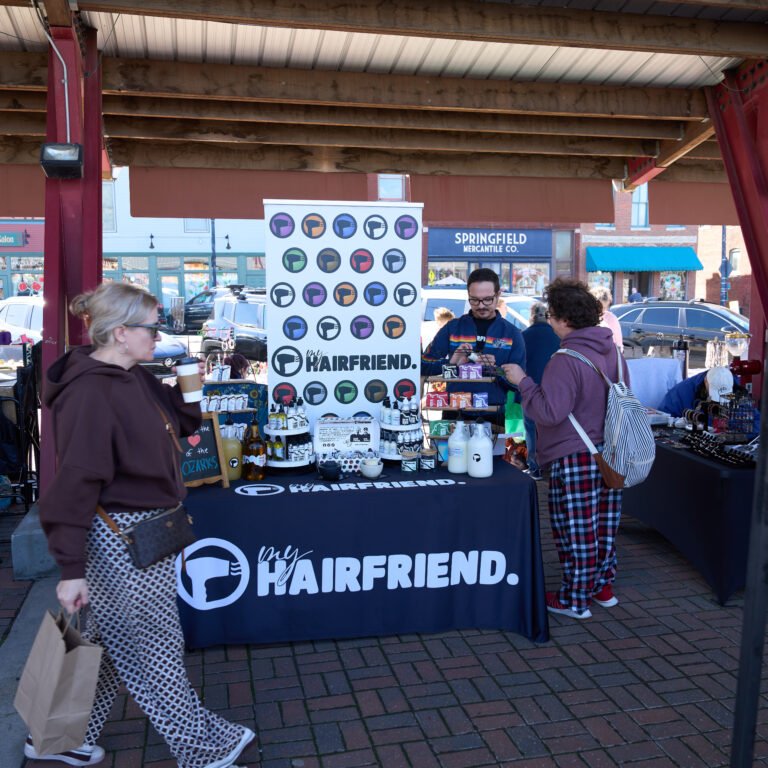 The My Hairfriend haircare booth with product displays at the C-Street City Market.