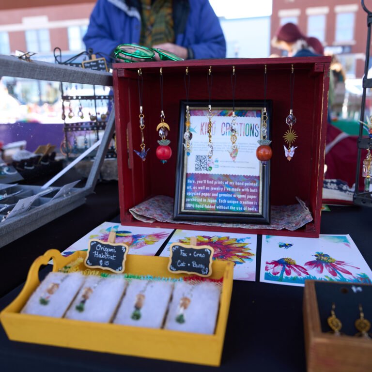 The Kiro Creations booth of hand-folded origami jewelry and watercolor prints at the C-Street market.