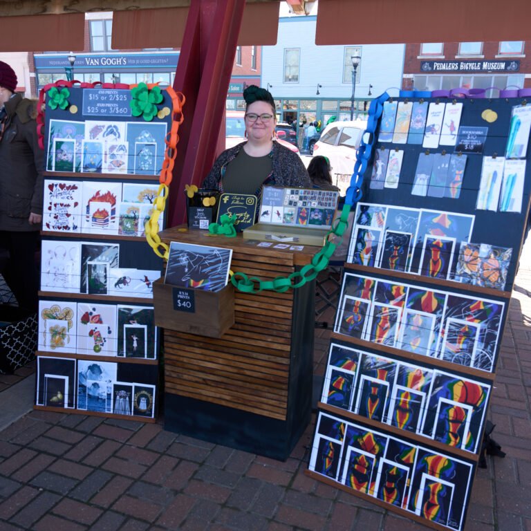 An artist at her Simply Katydud print booth on C-Street.