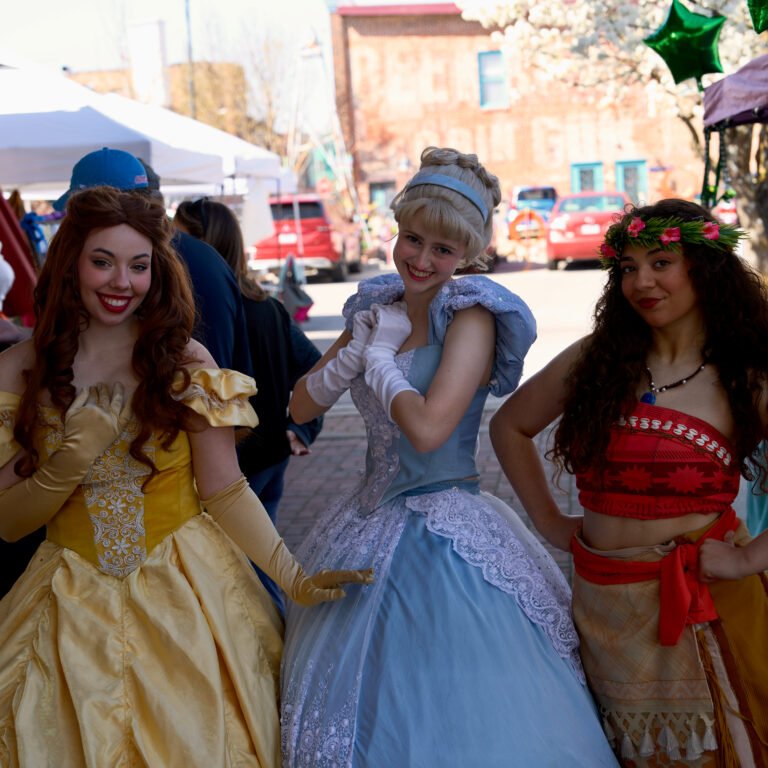 Three costumed princess performers pose during a spring festival day on Historic C-Street.
