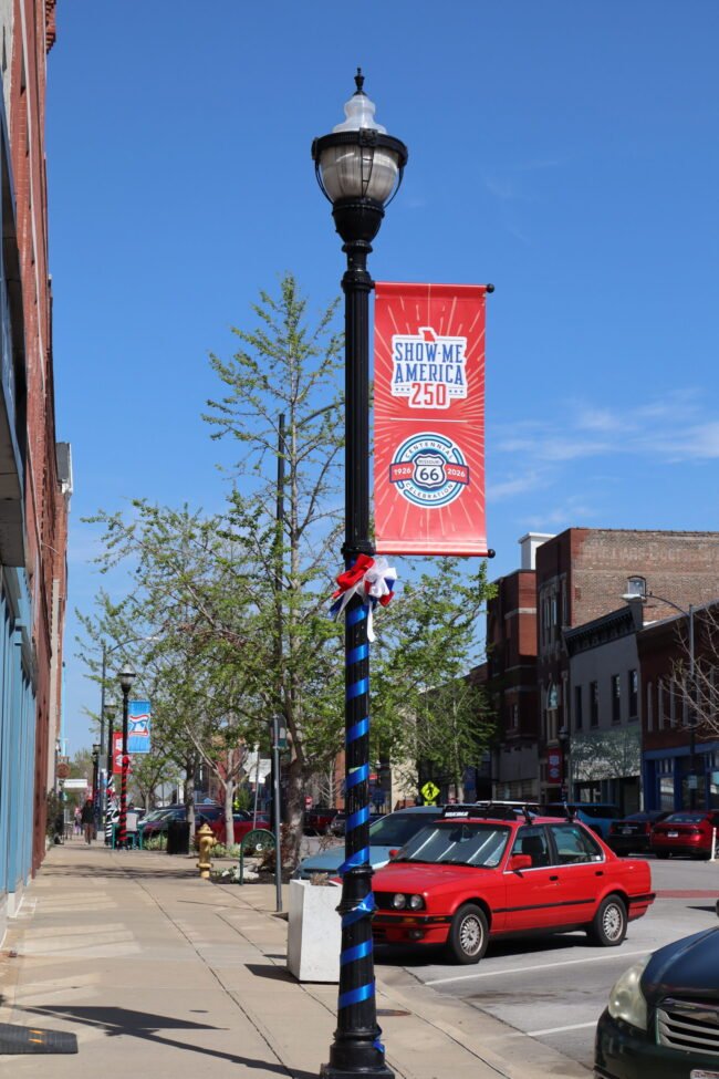 C-Street lamppost wrapped red white and blue with a Show-Me America 250 banner, Historic Commercial Street, Springfield.