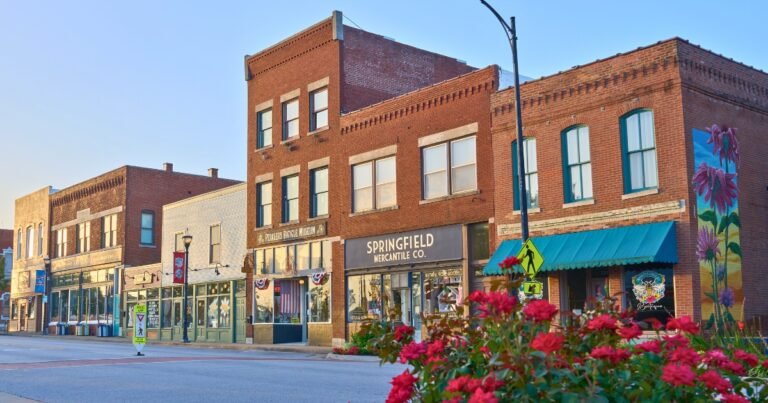 Historic Commercial Street brick storefronts with flower planters, including Springfield Mercantile, Springfield, MO.