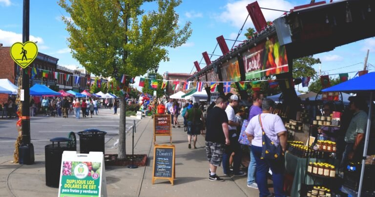 The C-Street City Market outdoor market with tents and shoppers on Commercial Street, Springfield, MO.