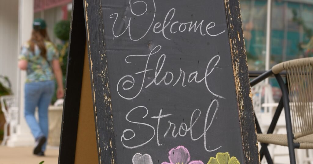 A Welcome Floral Stroll chalkboard sign with tulips on Historic Commercial Street, Springfield, Missouri.