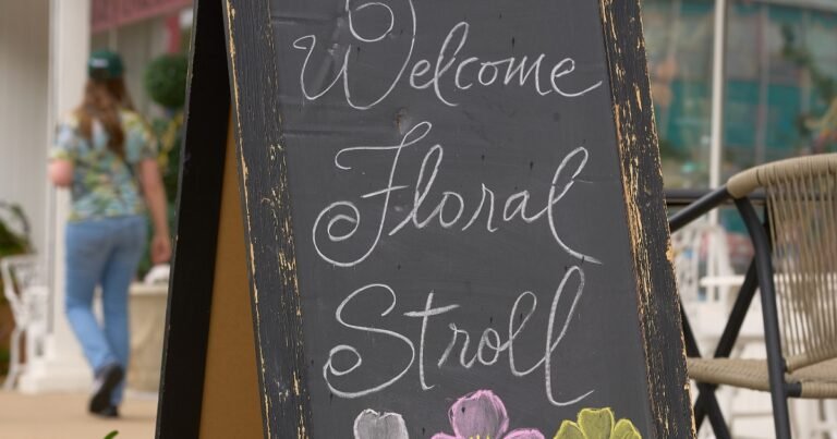 A Welcome Floral Stroll chalkboard sign with tulips on Historic Commercial Street, Springfield, Missouri.
