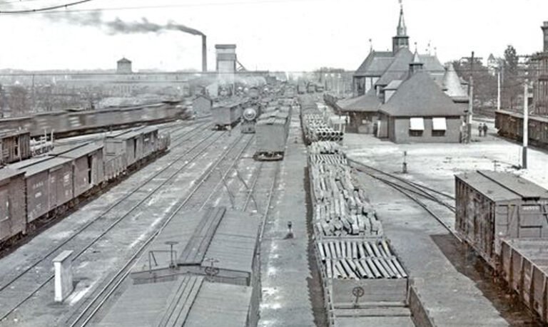 Historic Frisco rail yards with tracks and rail cars beside Commercial Street, Springfield, Missouri.