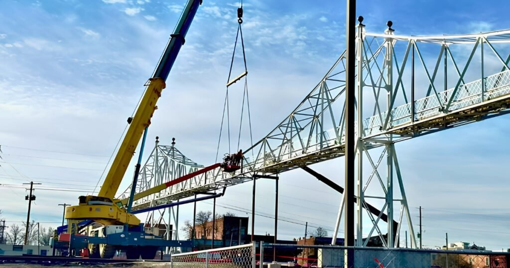 The Jefferson Avenue Footbridge under rehabilitation with a crane lifting a truss section, Springfield, Missouri.
