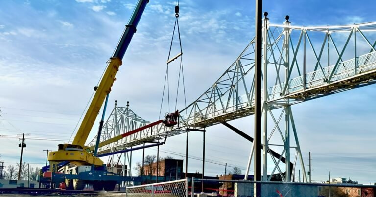 The Jefferson Avenue Footbridge under rehabilitation with a crane lifting a truss section, Springfield, Missouri.