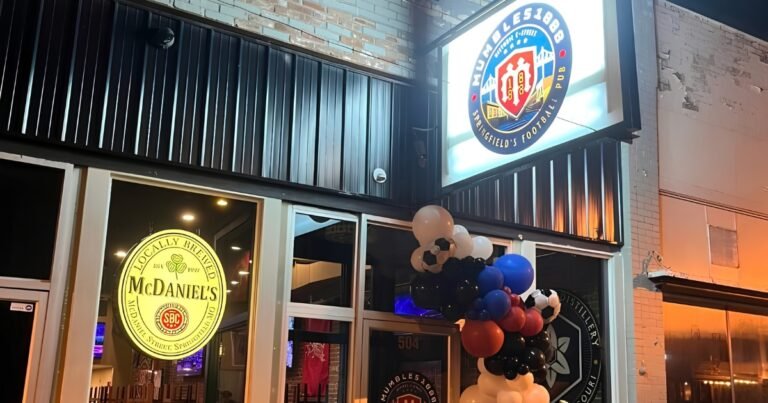 Mumbles 1888 pub storefront lit up at night with a balloon display on Historic C-Street, Springfield, MO.