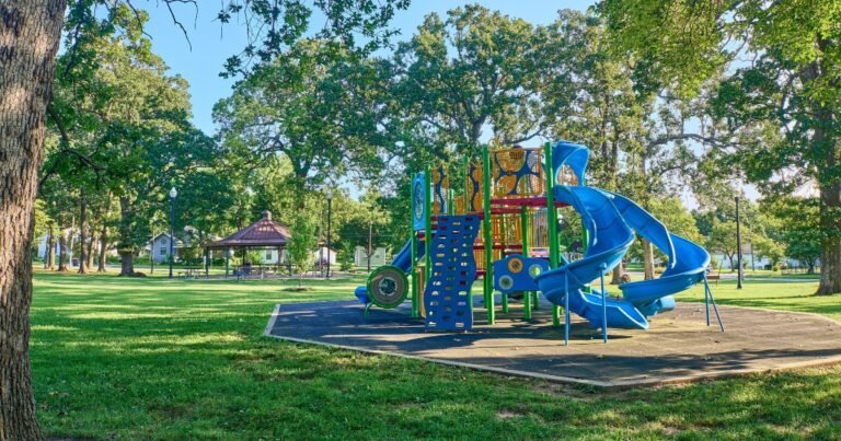 A neighborhood park playground with a colorful play structure near Historic C-Street, Springfield, MO.