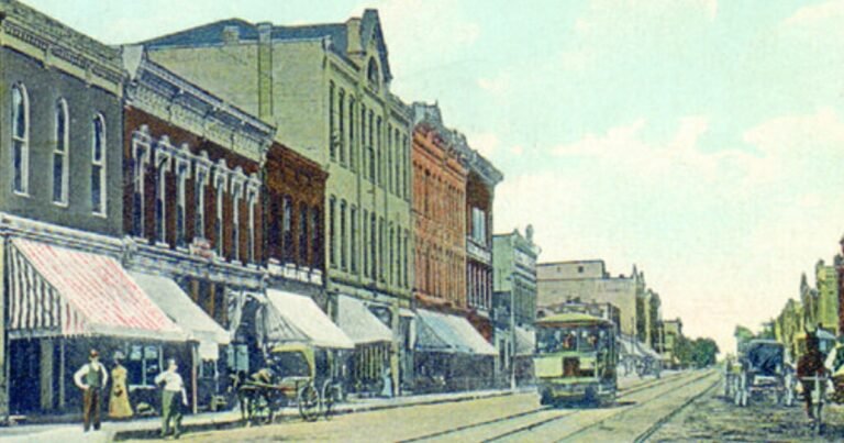 Vintage color postcard of Commercial Street with a streetcar and storefront awnings, Springfield, Missouri.