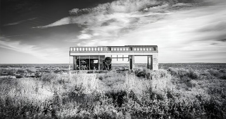 A black-and-white Route 66 photo of an abandoned building from the Two Voices One Road exhibit, Springfield, MO.