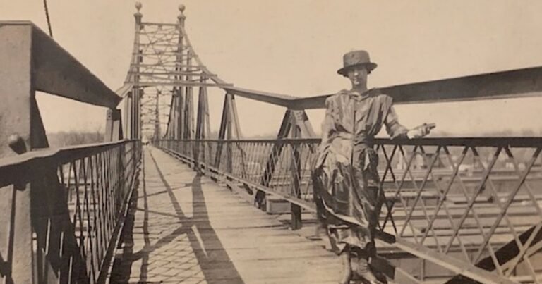 Historic photo of a woman on the Jefferson Avenue Footbridge above the Commercial Street rail yards, Springfield, MO.