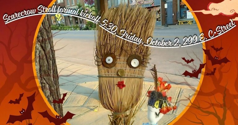 Whimsical straw scarecrow with button eyes and flowers displayed along Historic Commercial Street in Springfield, Missouri, for the October Scarecrow Stroll.